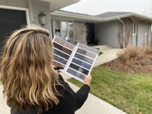 woman looking at Design samples next to a home