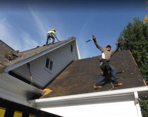 workers taking off a roof