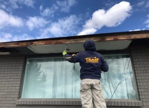 worker taking off a roof